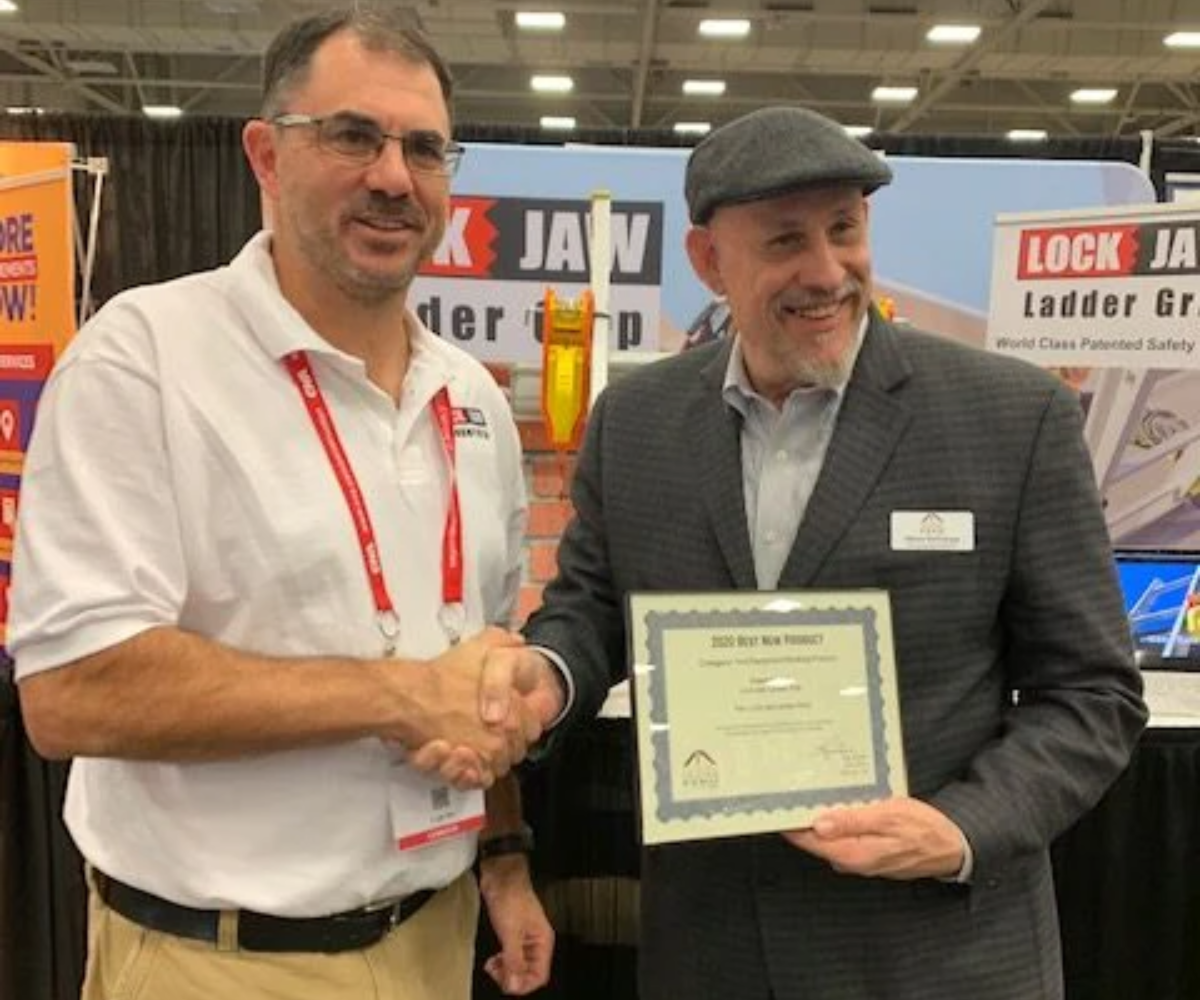 Lock Jaw Ladder Grip representative receives the 'Best New Product' award at a trade show, highlighting innovation in ladder safety solutions.