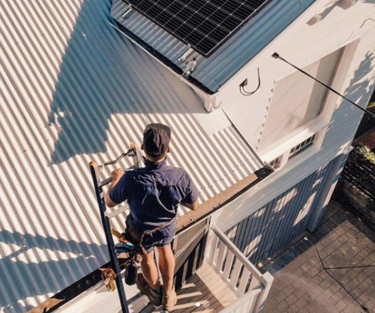 A person using lock jaw ladder for safety is about to install a solar panel