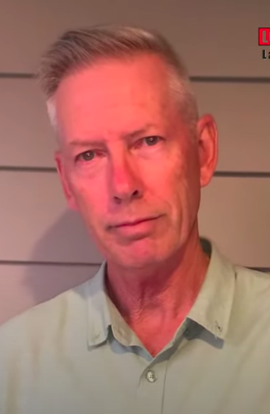 A man with light hair looks directly at the camera.