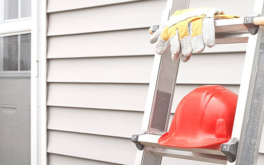 Two extension ladders secured to a roofline with Lock Jaw Ladder Grips