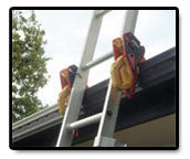 A ladder is shown with orange ladder jacks attached to it.