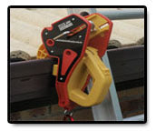 A red and yellow Lock Jaw Ladder Grip is clamped onto a ladder.