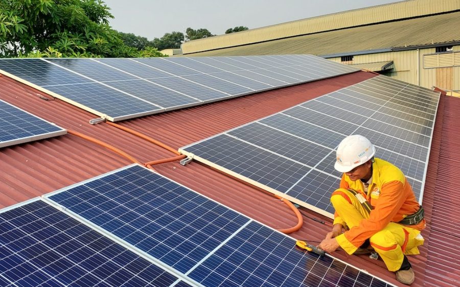 Solar installer working on a rooftop array