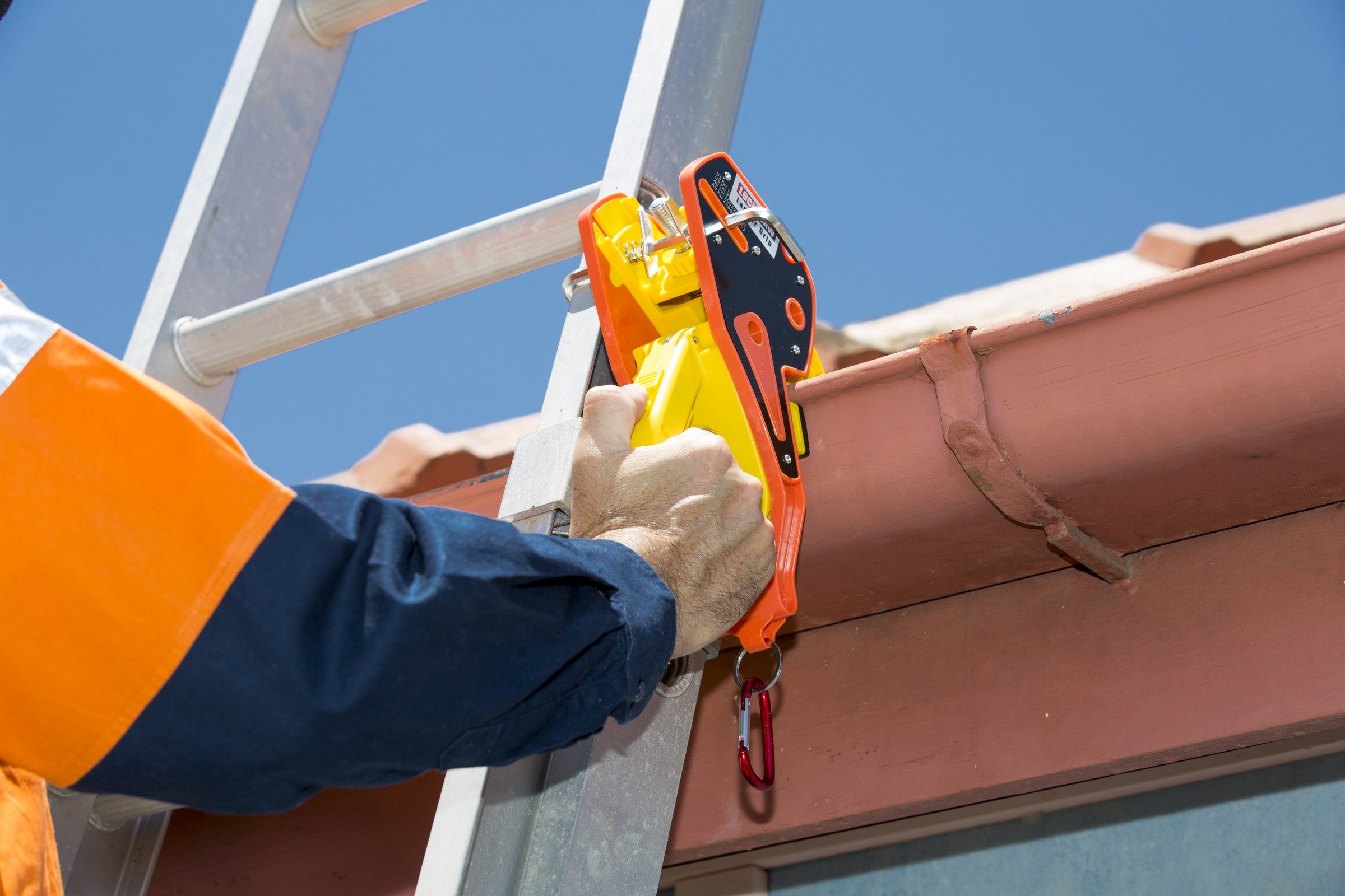 A Lock Jaw Ladder Grip in use with an extension ladder