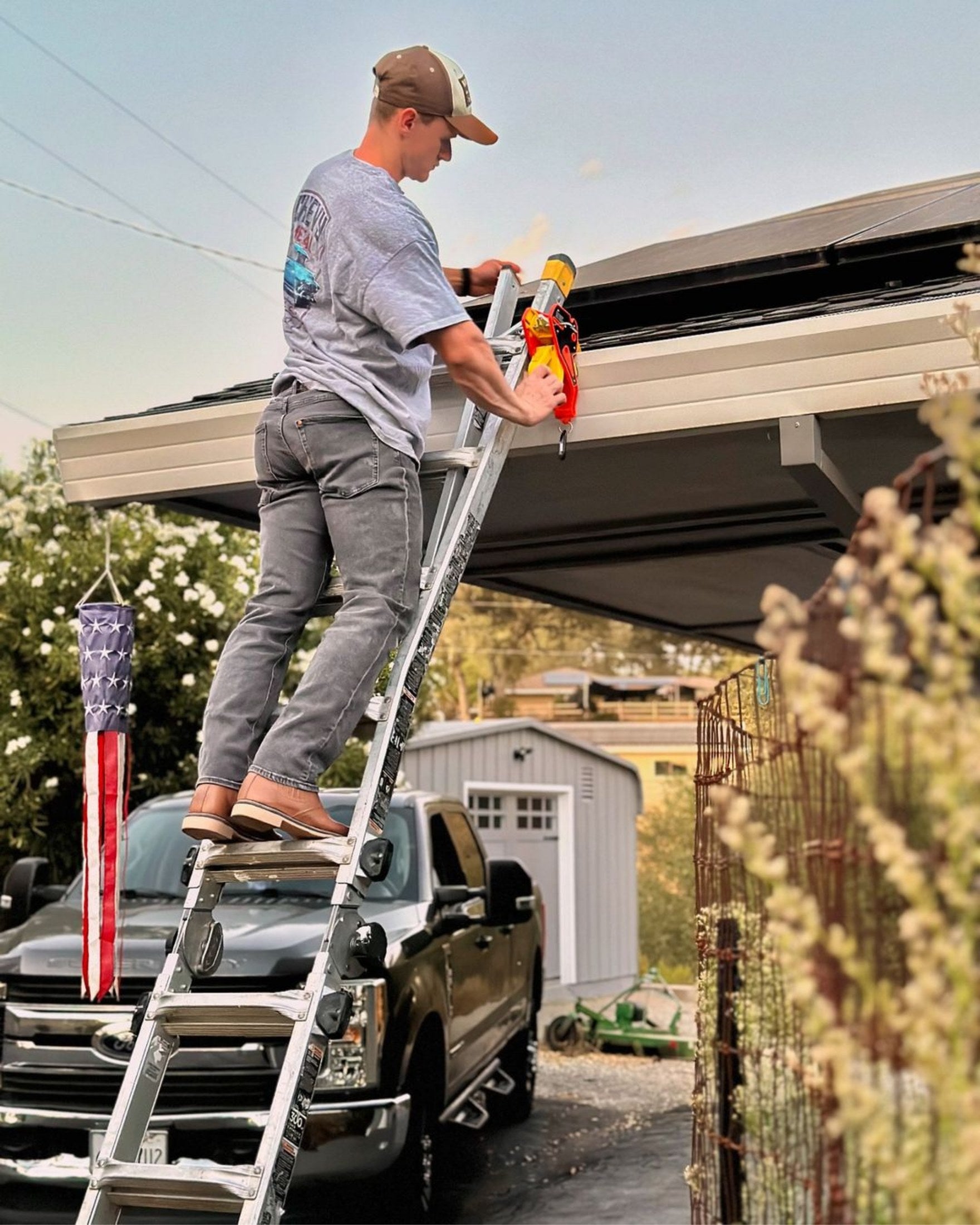 A Lock Jaw Ladder Grip securing an extension ladder at a gutter