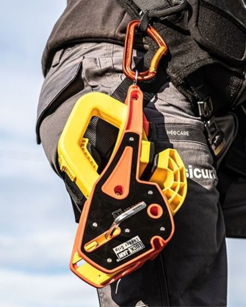 Lock Jaw Ladder Grip carried beside an extension ladder